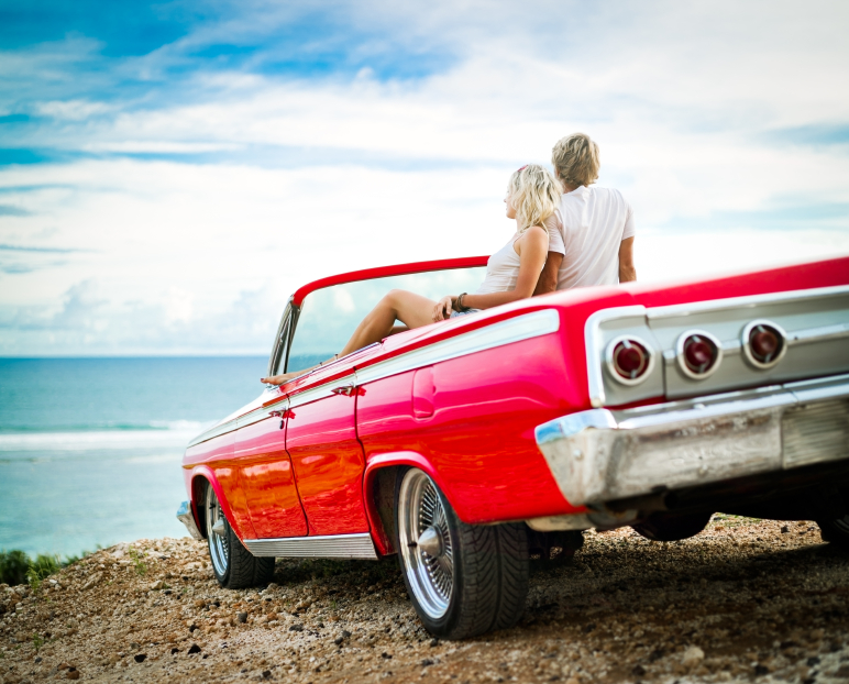 Classic car at the beach with a couple