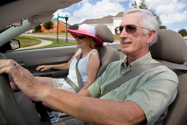 elderly couple driving in car