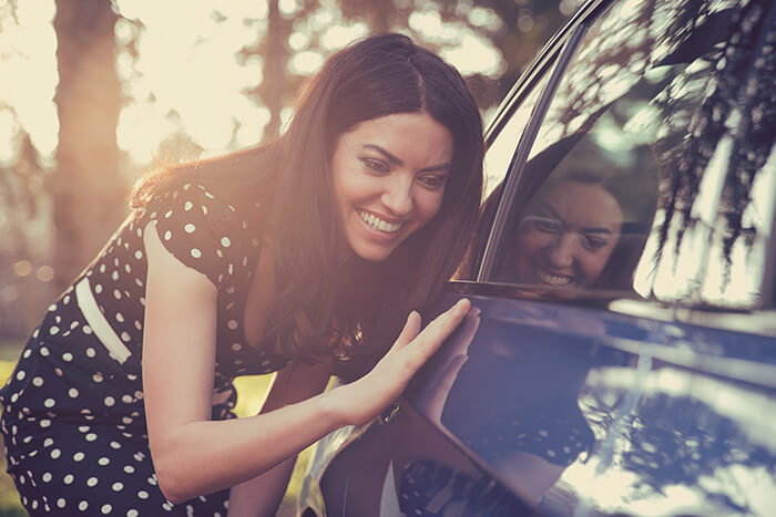 Woman next to car