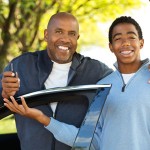 Parent handing car keys to his teen driver