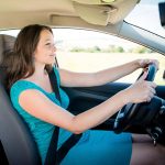 Teen girl driving down the road