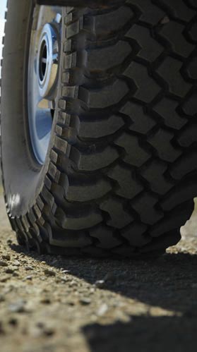 Car tire on gravel